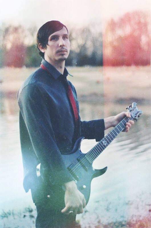 Hunter Eastland holding a guitar